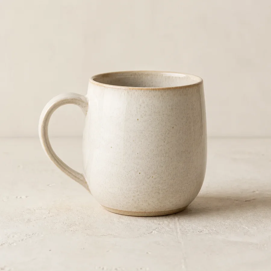 Handmade ceramic mug viewed from the left